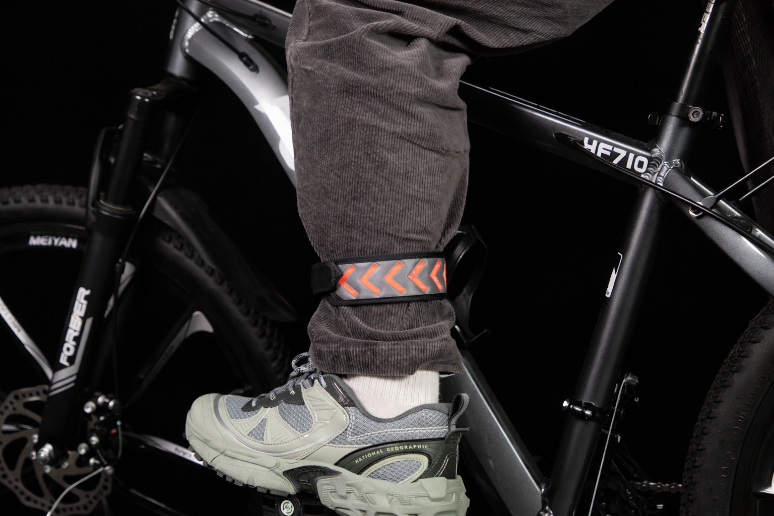 GlowStride LED reflective safety leg band worn on the ankle for low-light cycling