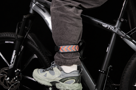 GlowStride LED reflective safety leg band worn on the ankle for low-light cycling