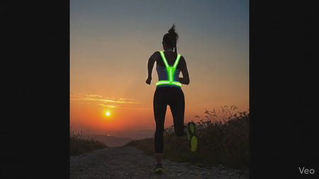 GlowStride LED Reflective Running Vest — Runner at sunset wearing high-visibility vest
