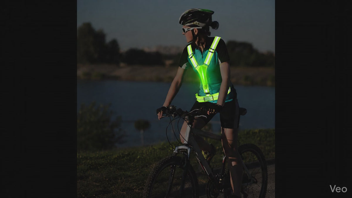 GlowStride LED Reflective Running Vest — Night cyclist wearing safety vest over jersey